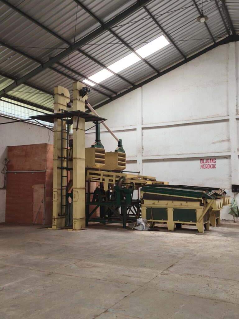 Swarna Agro's density sorting and grading machine, a critical quality control step for processing wholesale Indonesian arabica and robusta coffee beans to ensure uniform size, density, and consistent Grade 1 export quality for international partners.